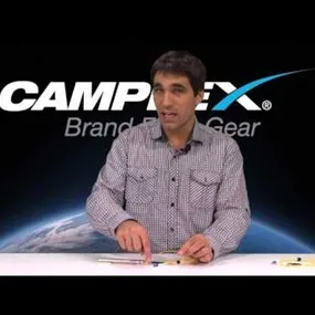 Man presenting at the Camplex Brand Fiber Gear desk about using a visual fault locator